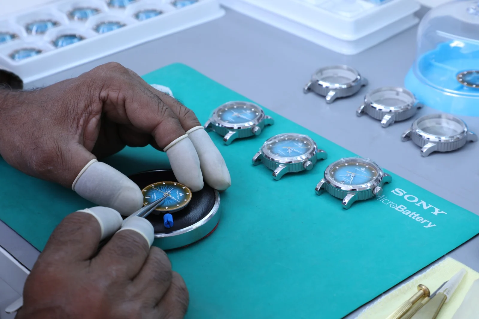 Watchmaker hands working on precision watch components